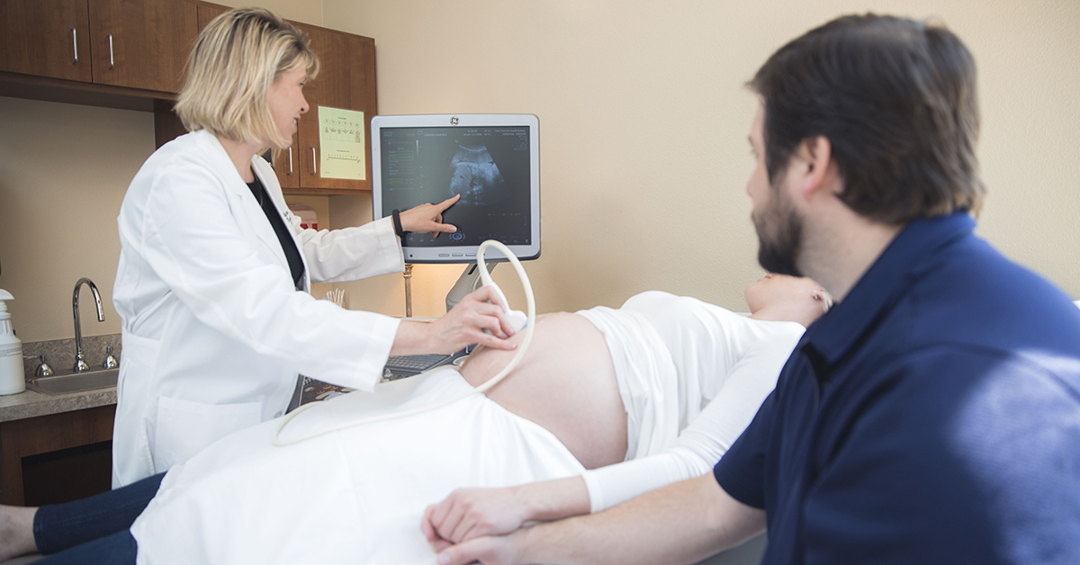 Dr. Phy taking an ultrasound on pregnant woman 