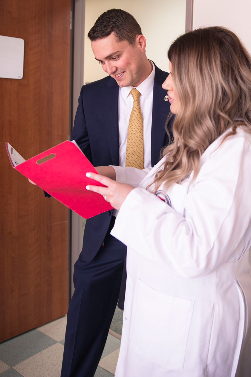 TTUHSC student and healthcare administration reviewing file, related to the field of medical and health services managers.