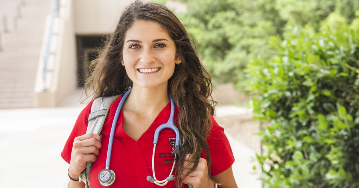 TTUHSC Nursing Student with backpack standing outdoors.