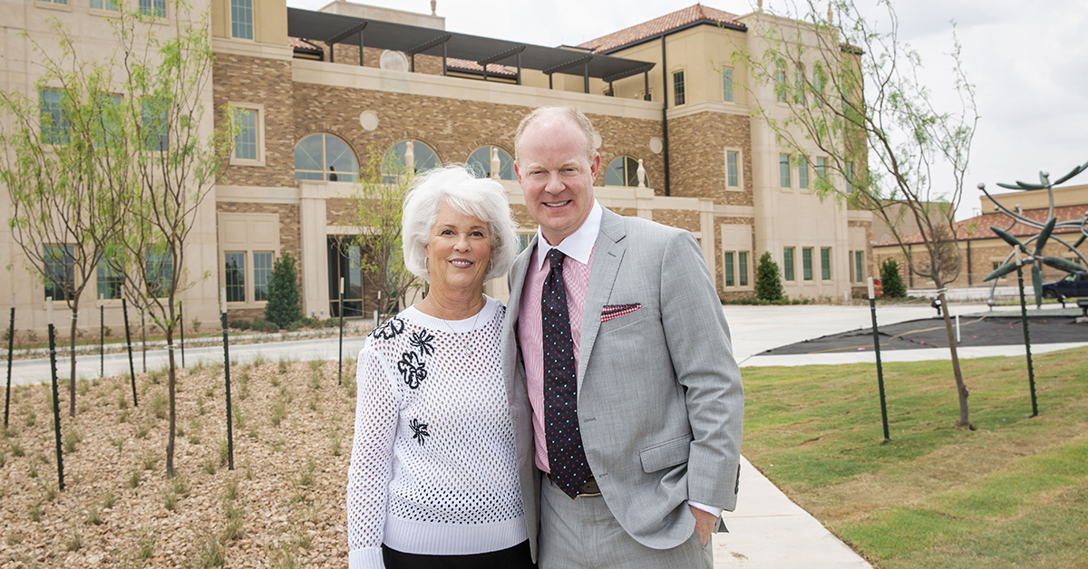 The Taylors stand in front of the new University Center building