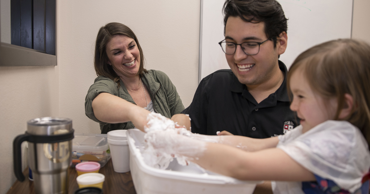 TTUHSC speech language pathology student interacting with a patient during an activity.