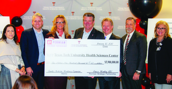 Tedd Mitchell standing with the Permian Strategic Partnership for the donation check presentation.