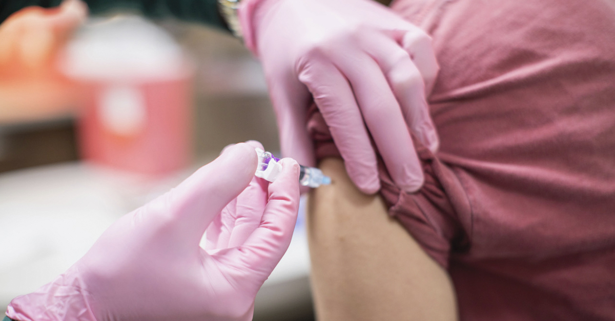 Medical worker giving a vaccine shot to a patient.