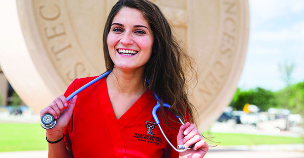 Nursing student in front of the TTUHSC seal, what makes a great nurse?