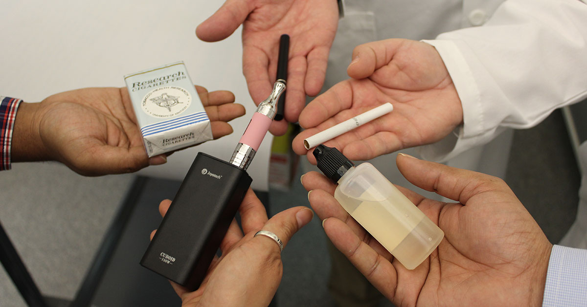 lab assistants holding smoking devices