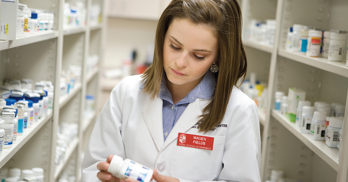 TTUHSC pharmacy student reviewing a bottle label.