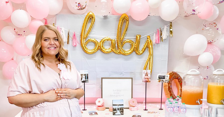 Megan McCrory in front of balloons at her baby shower