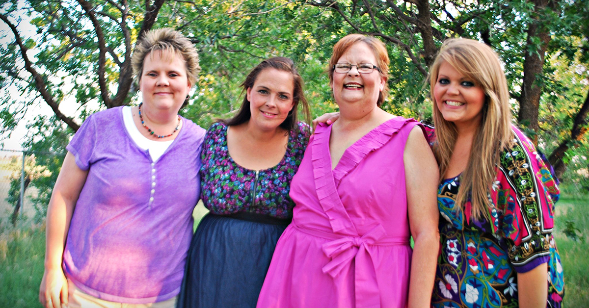 Megan MCcrory and her family standing in a line outside in front of trees