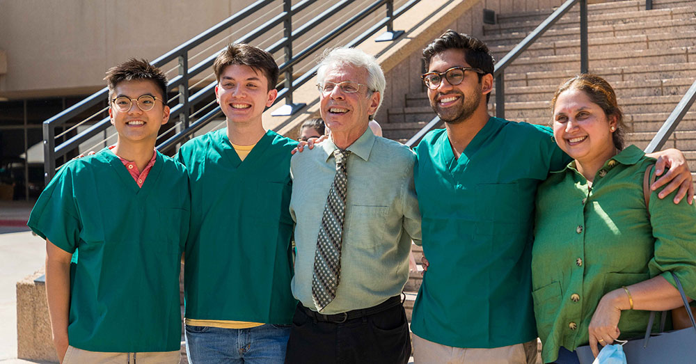 Steven L Berk, MD, posing with students at event