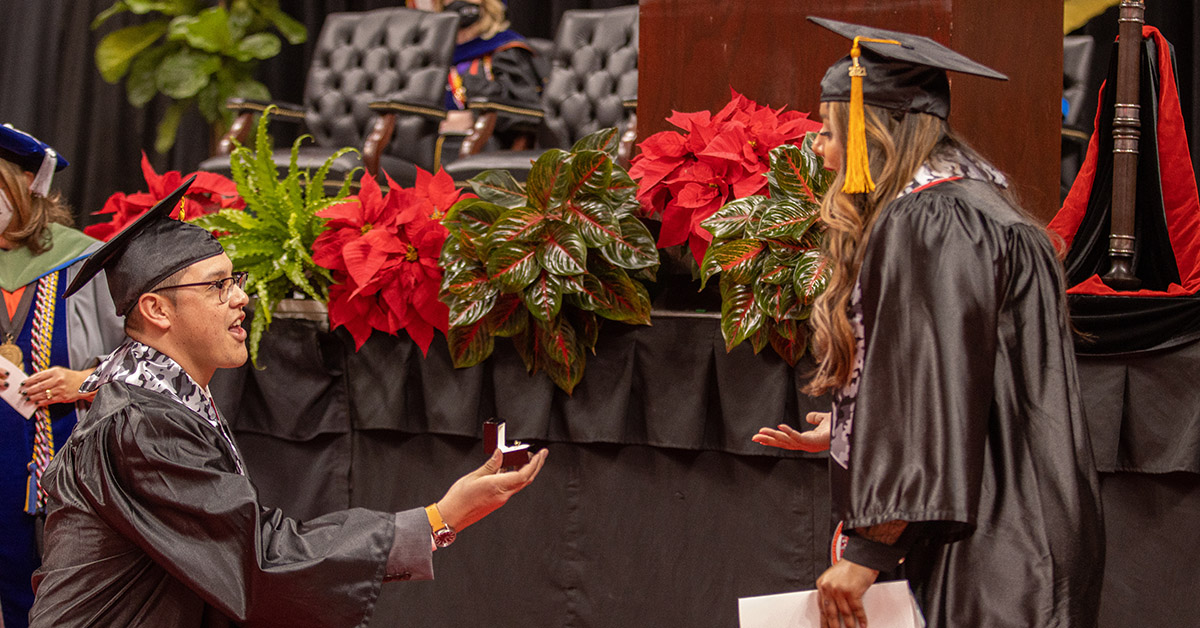 Maugeri and Del Rio proposing on stage at graduation ceremony