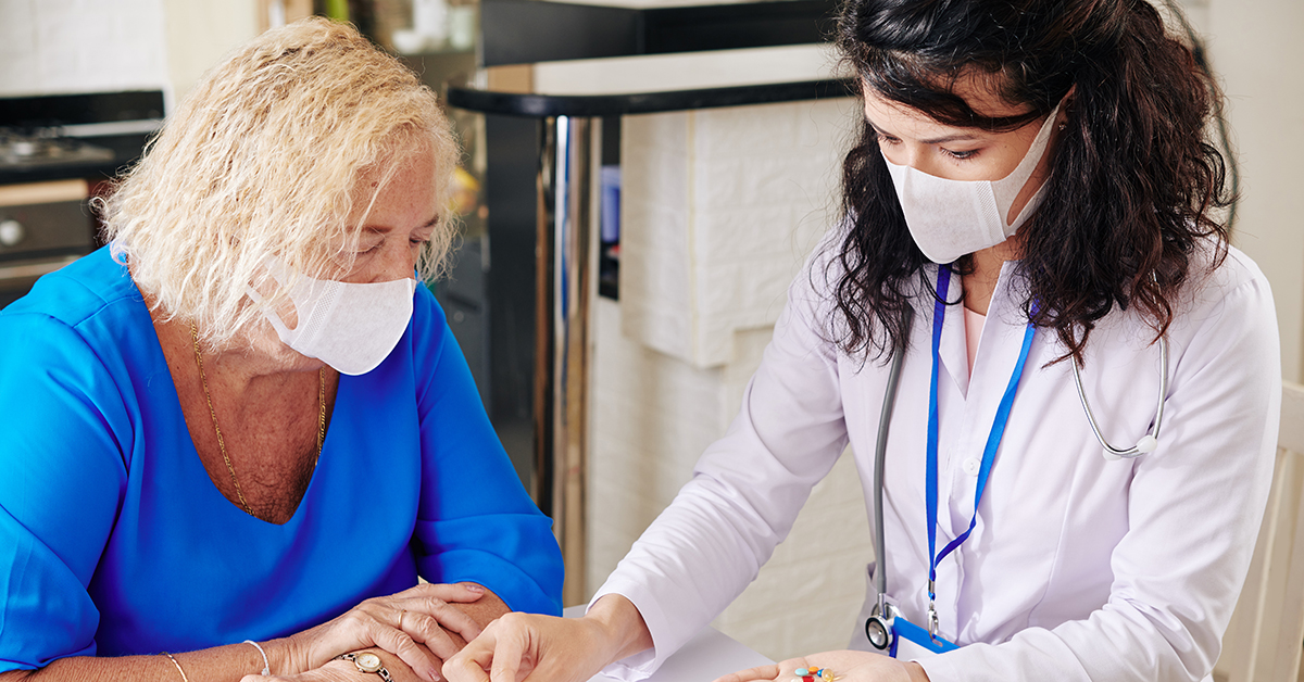woman and health care professional wearing masks