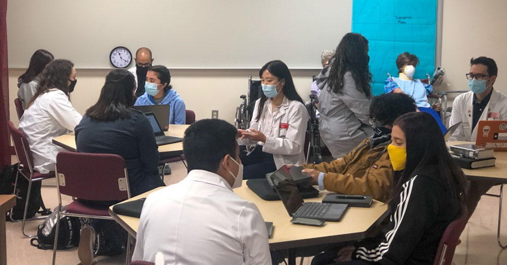 students sitting with their health care mentors