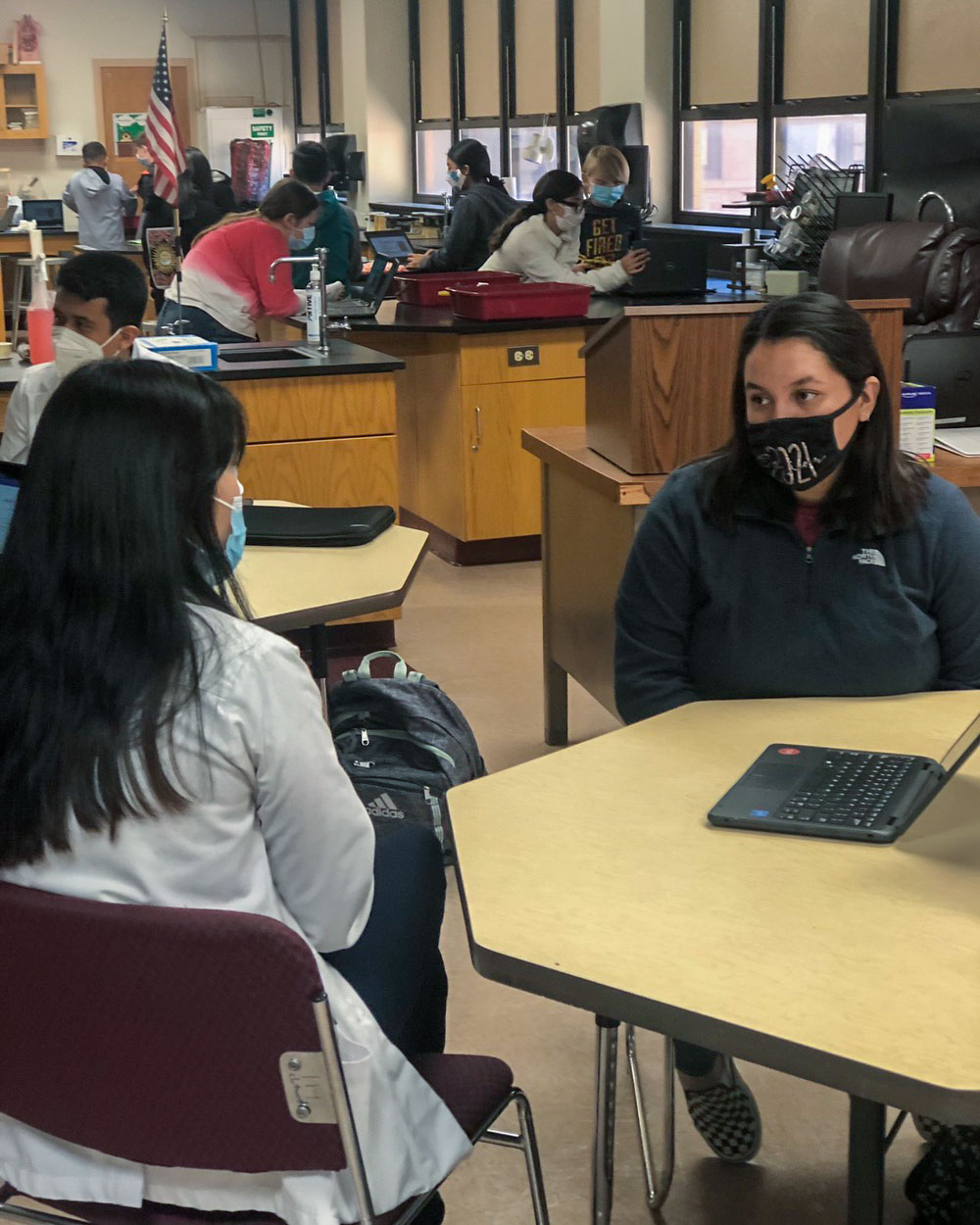 rural health mentor and student in discussion wearing masks