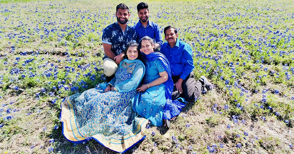 Stacy and Steven Philip with their family in a bulebonnet field