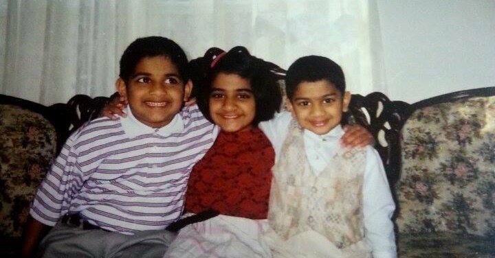 Stacy and Steven Philip with their brother on a couch as children