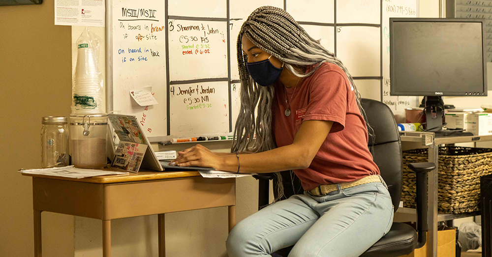 volunteer at the free clinic at TTUHSC provides tele health care on a laptop