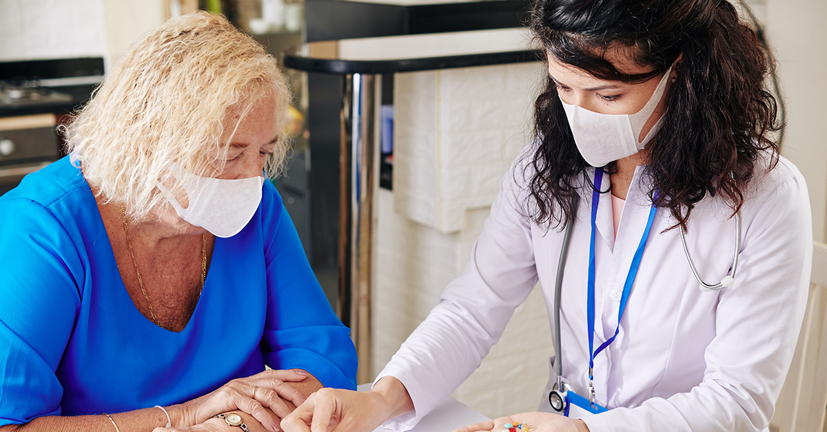 two women in masks in a professional medical setting