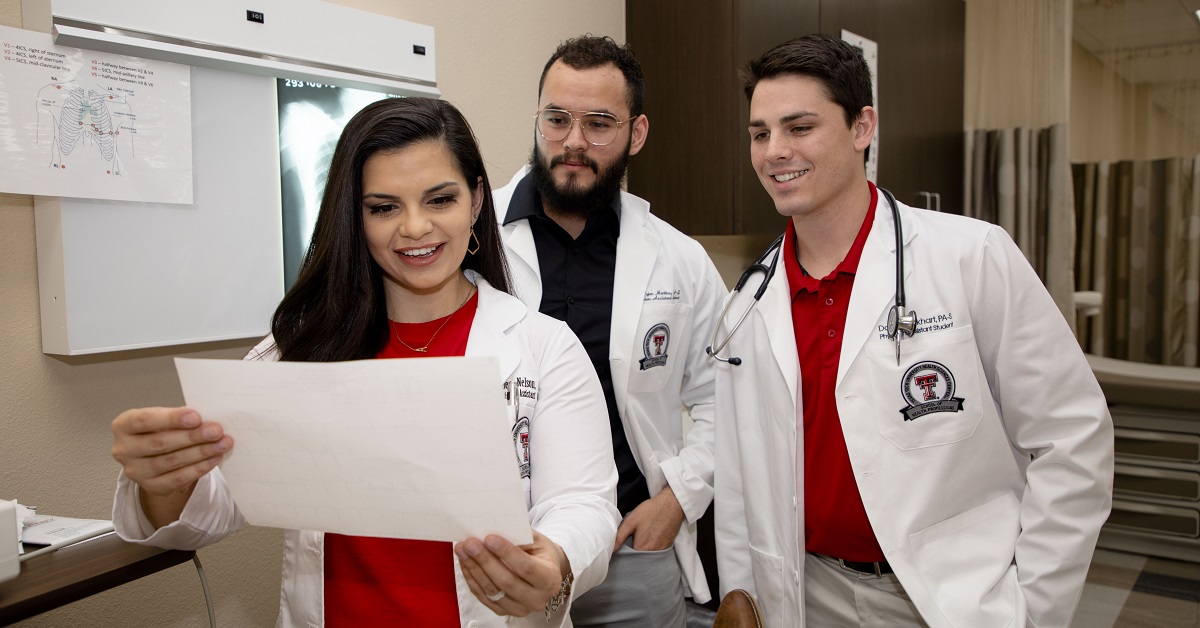 students in the school of health professions looking at a piece of paper