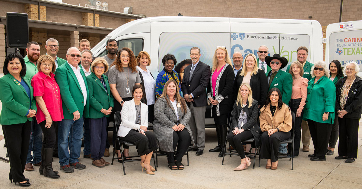 Donors and staff stand in front of "Care Van" mobile unit.