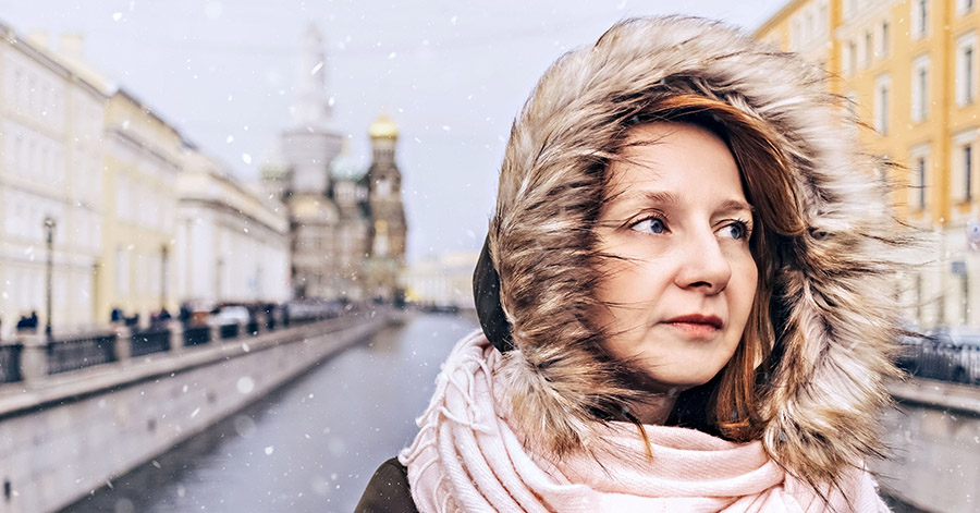 woman standing in the cold with a hood on