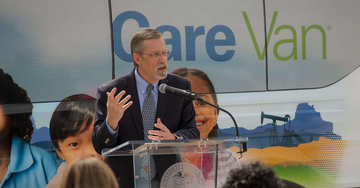 Timothy Benton, M.D., speaks in front of "Care Van" mobile unit.