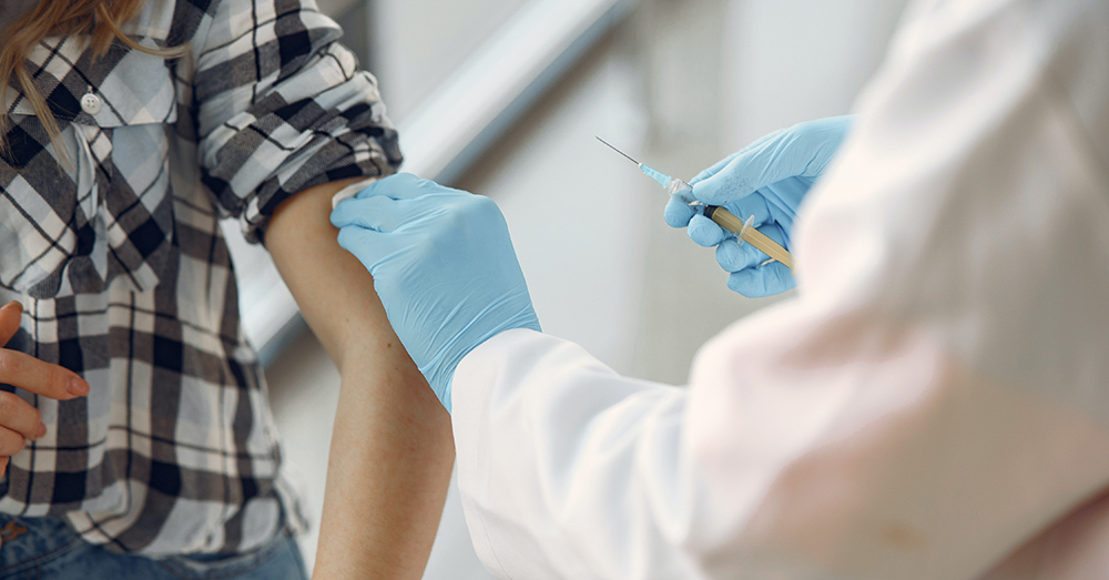 woman's arm recieving a vaccine