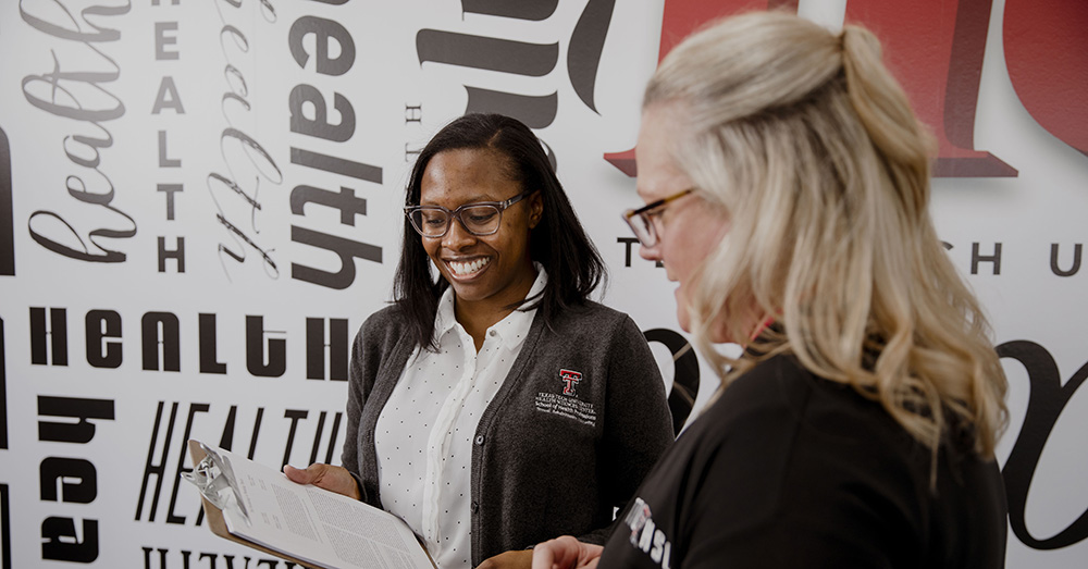 counseling professionals talking with a clipboard