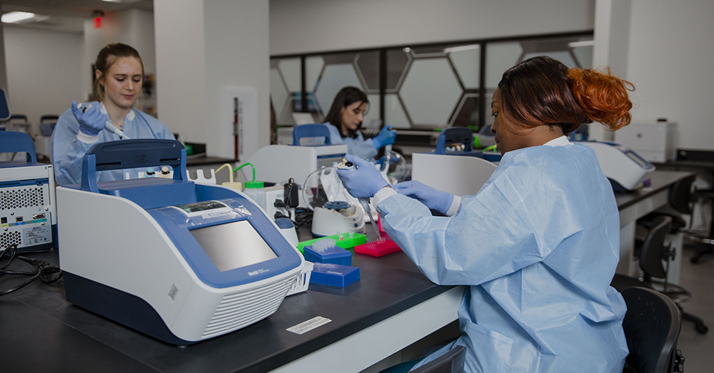 students engaging in the training of molecular pathology in a lab setting