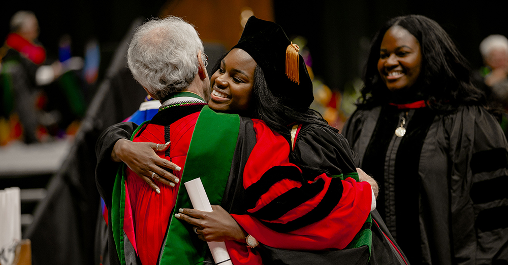 graduates during ceremony wearing caps and gowns