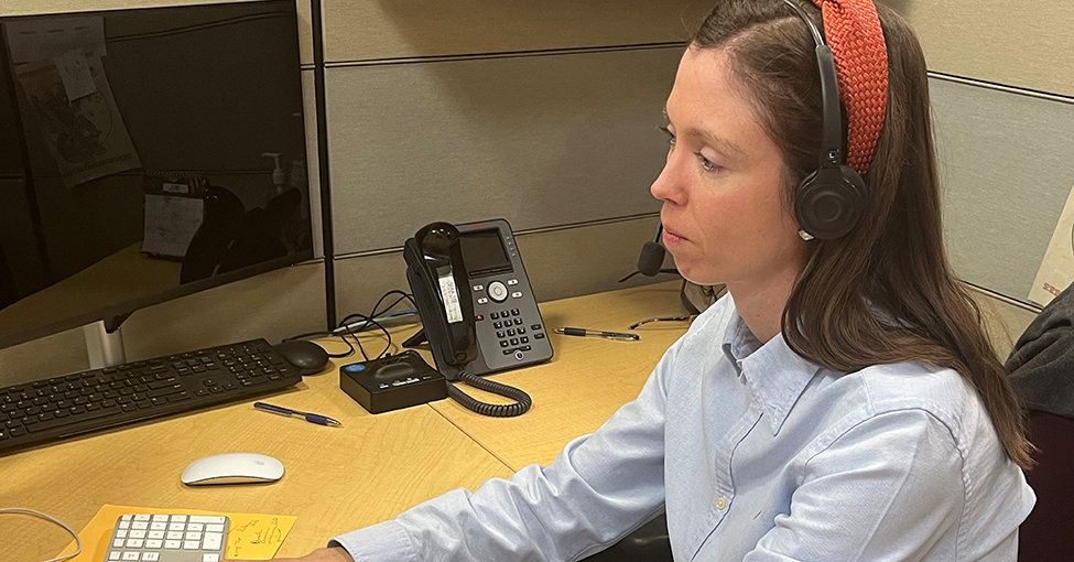 person working with headset at call center