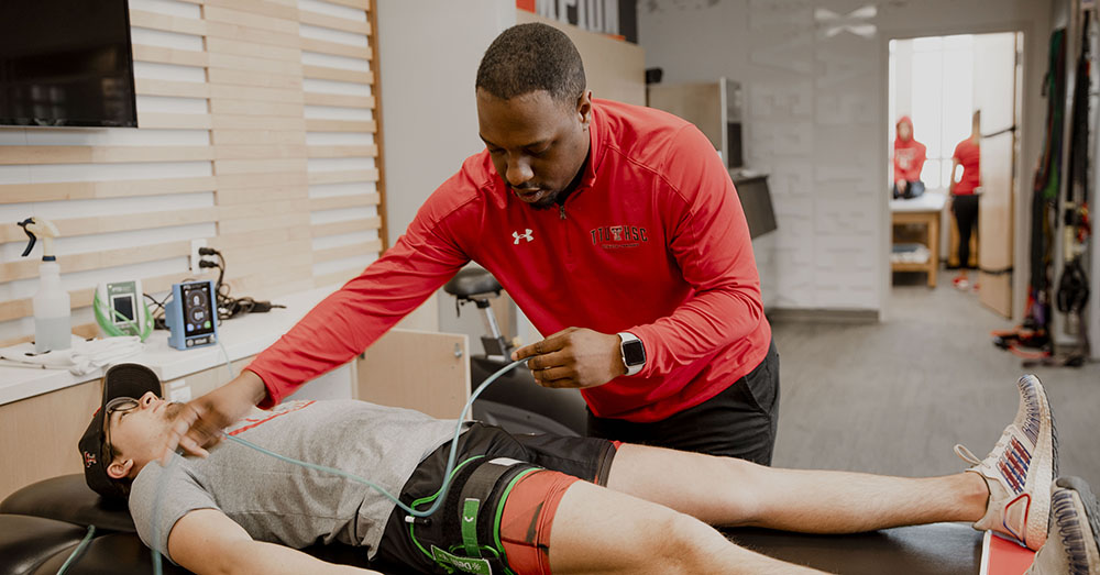 athletic trainer working with a patient