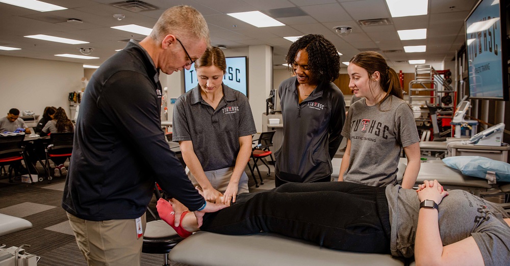 athletic training students learning with a patient