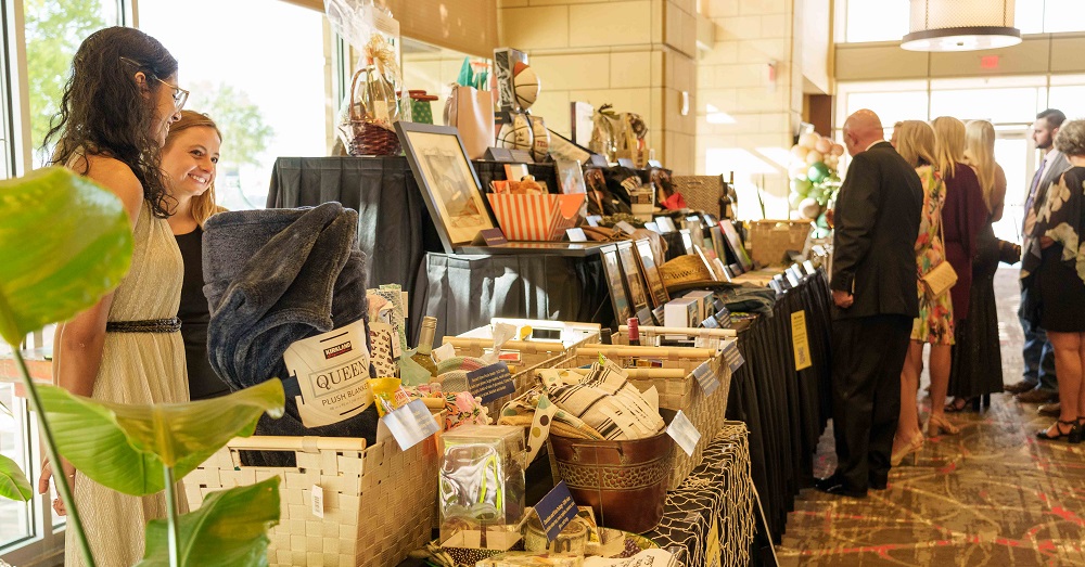 people attending a silent auction for Lubbock City Lights