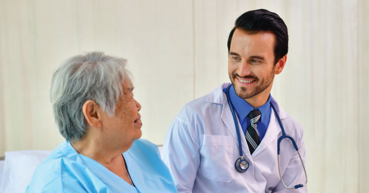 doctor smiling at an senior patient