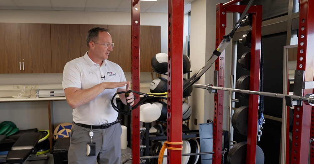 Toby Brooks, Ph.D., using fitness equipment