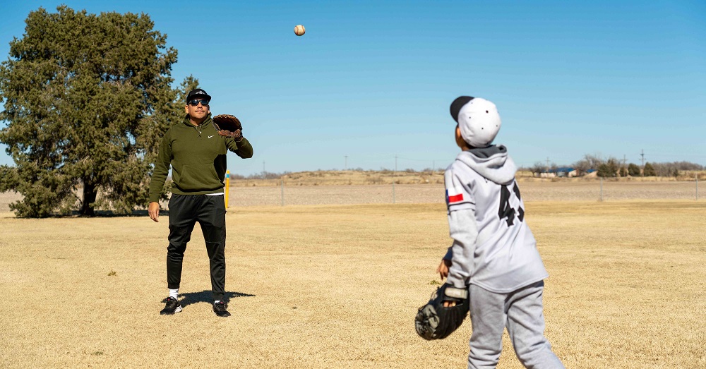 man and son playing catch outdoors