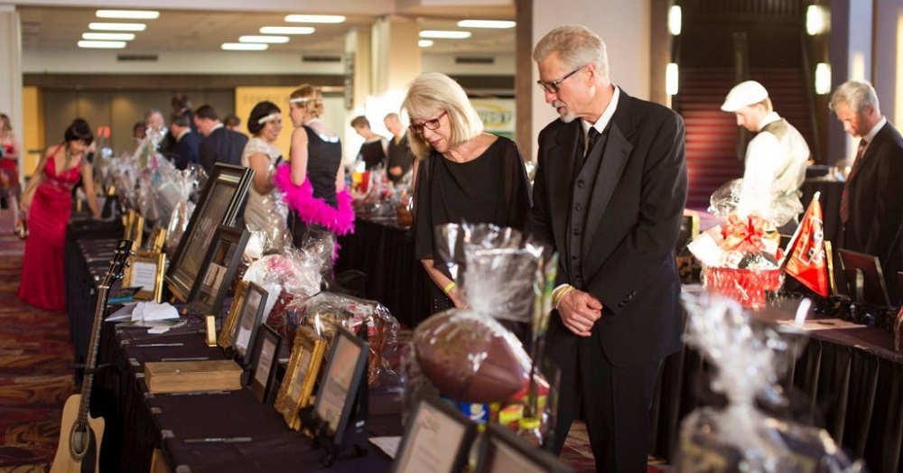 Individuals participating in silent auction