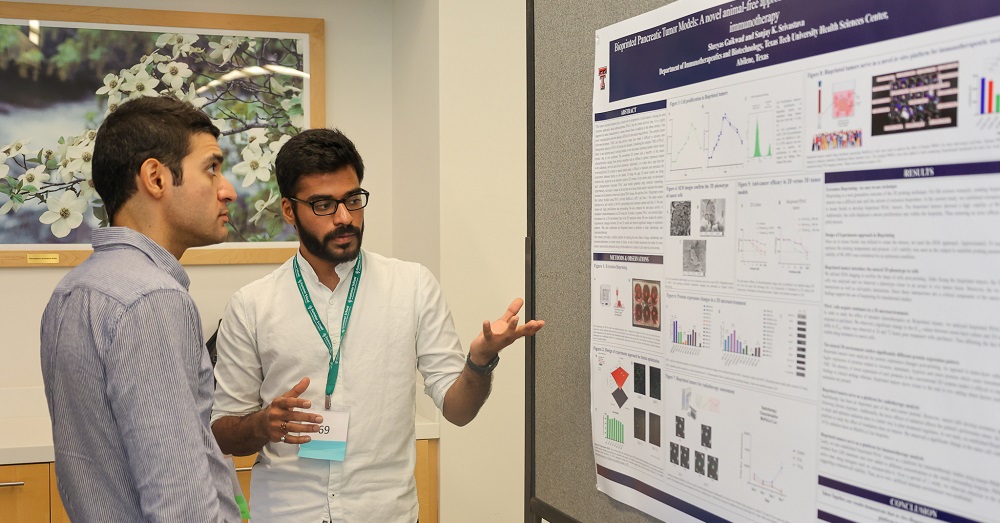 Shreyas Gaikwad, a Ph.D. candidate, with a presentation board for his studies