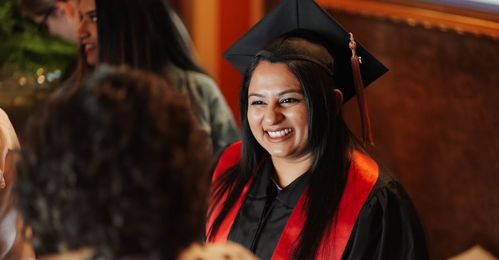woman smiling while graduating from the school of population and public health at TTUHSC