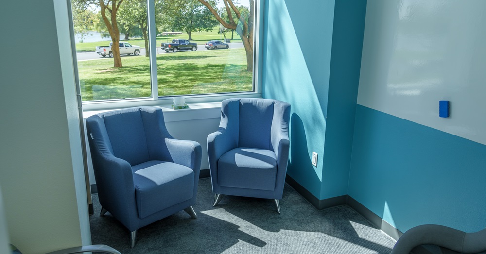 two chairs sitting by a window at the new relational health center