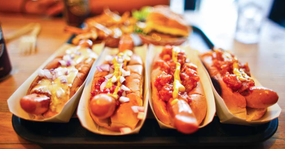 Plate of hot dogs covered in chili.