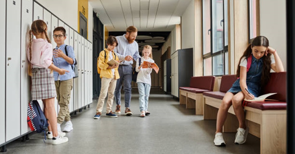 children and school professionals in a school hallway