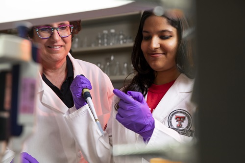 two experts in lab coats work in a lab