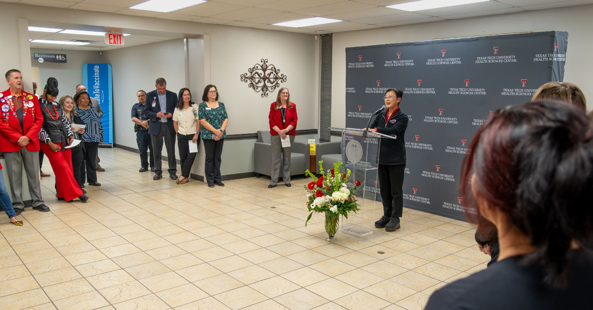 Woman nursing dean speaks at a podium.