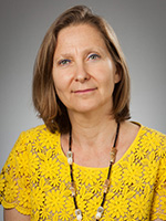 Woman smiles for headshot.