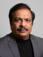 Man smiles for headshot.