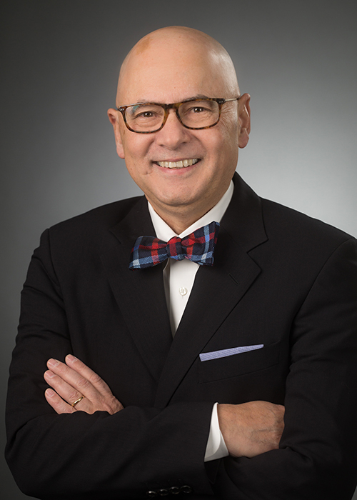 Male TTUHSC medicine dean smiles, wears a suit, and poses for a photo.