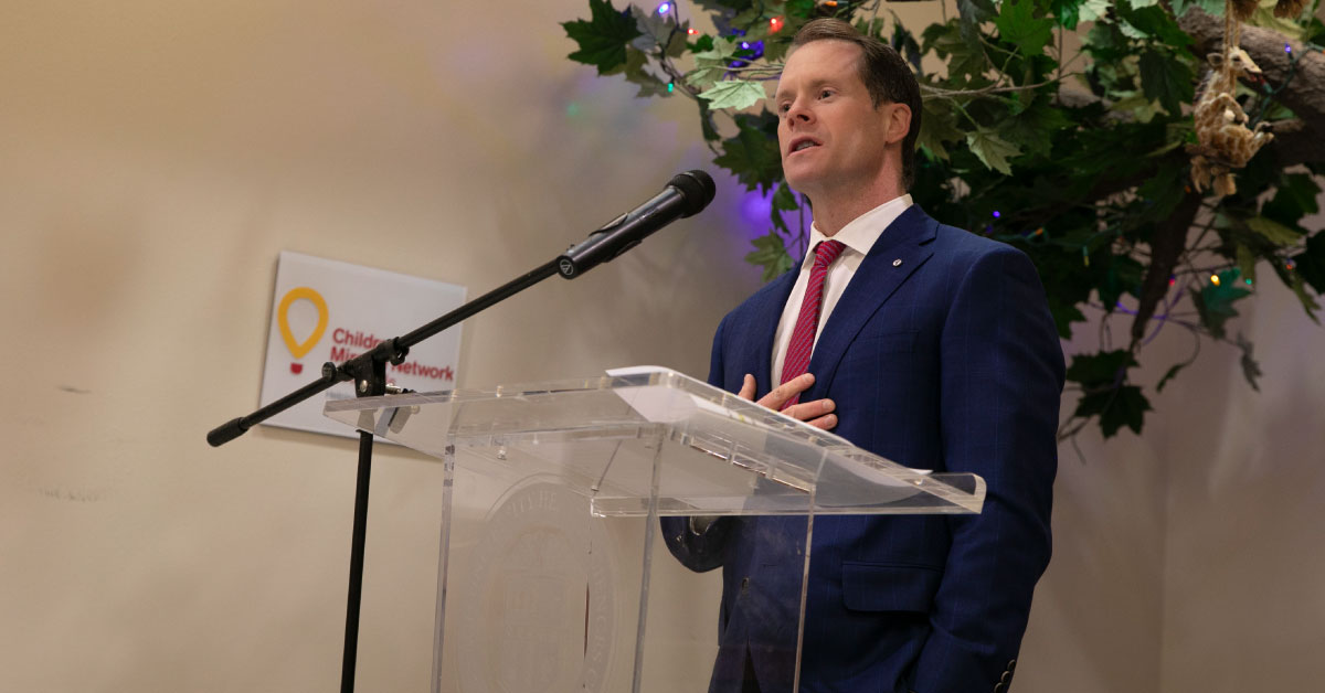 Man speaks at a podium.