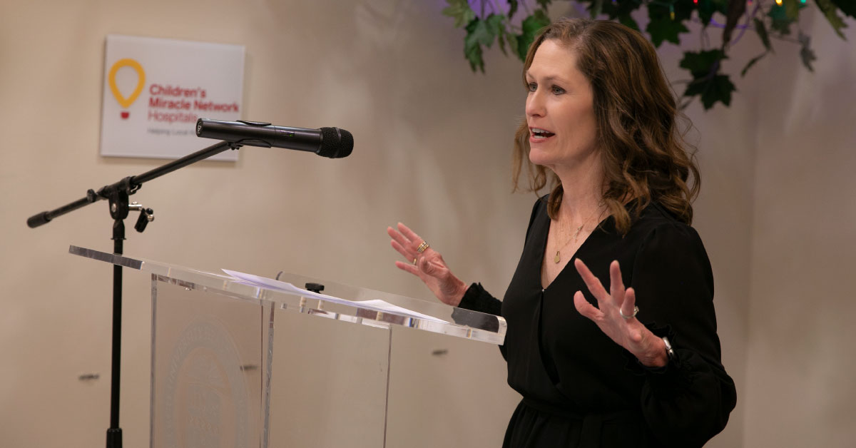 Woman speaks at a podium.