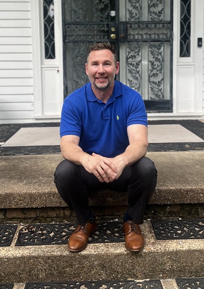 man sitting on steps, smiling